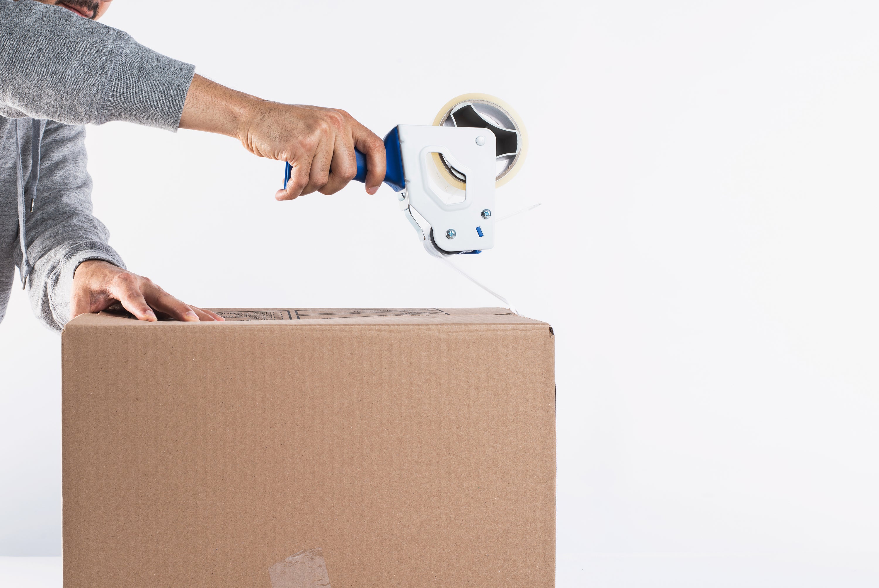 using-a-tape-dispenser-to-close-up-a-box